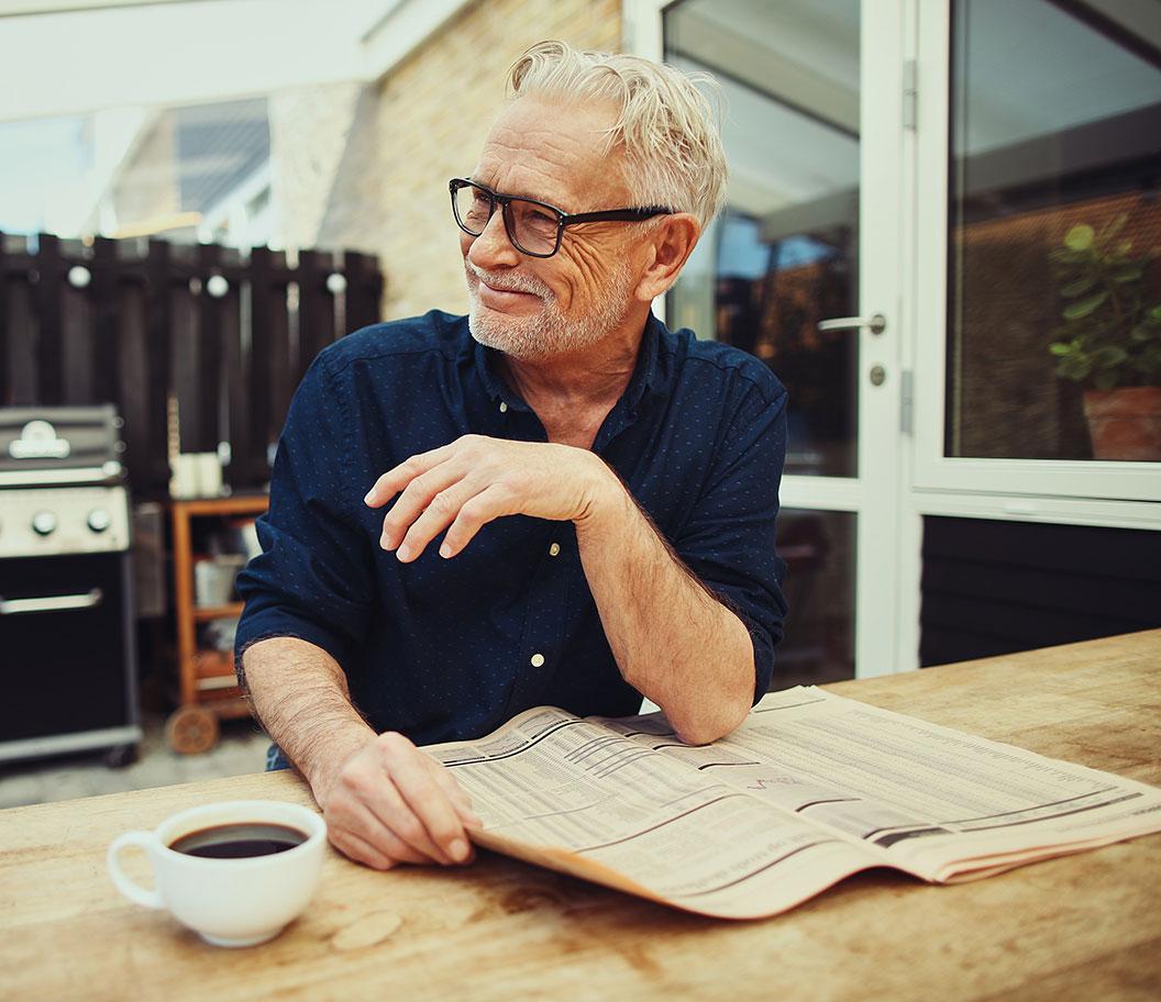 Man smiling and holding a paper